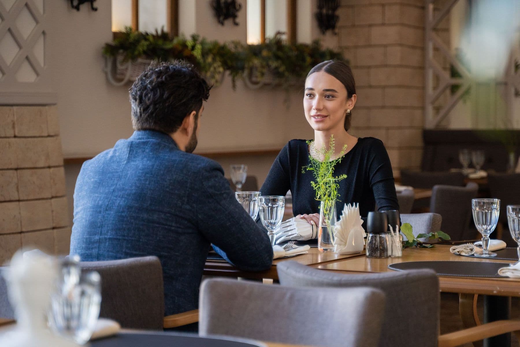 A man and a woman meeting for lunch at a quiet restaurant table.